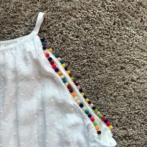 White tank top with multi—color pom pom detail